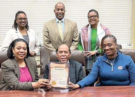 On hand for the proclamation ceremony recently were, from left, Coffee County Association of Service Agencies President Peggy Contreras, Mayor Cooper and Enterprise Councilwoman Sonya Rich. Standing, from left, are Enterprise Housing Authority Director Shana Demby, Enterprise City Schools Superintendent Zel Thomas and Enterprise Library Director Shelia Harris. 